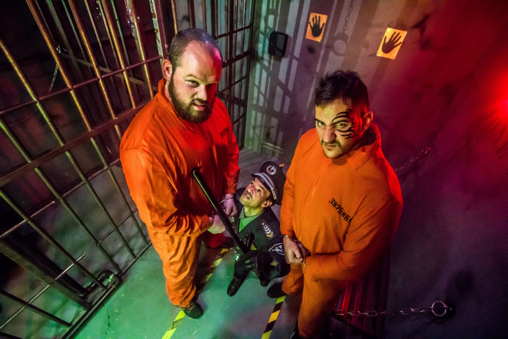 Deux detenus avec un gardien de prison